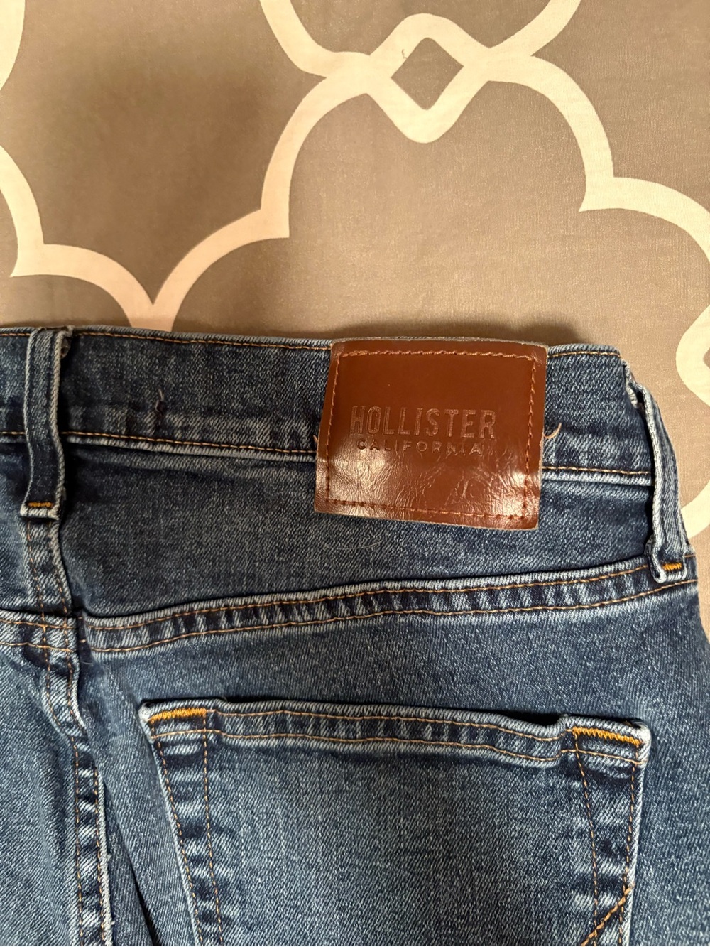 Hollister High-Rise Medium Blue Denim Jeans with Brown Patch
